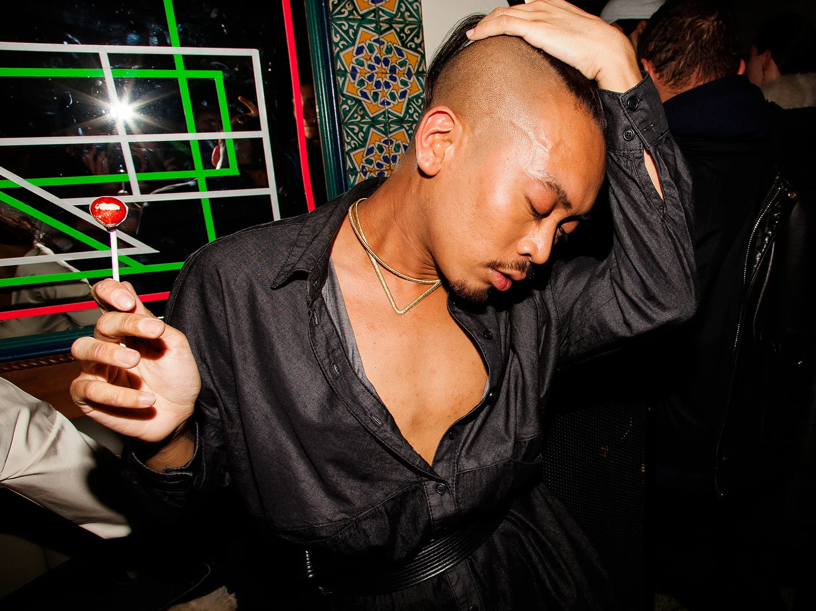 Nightlife portrait with a lollipop